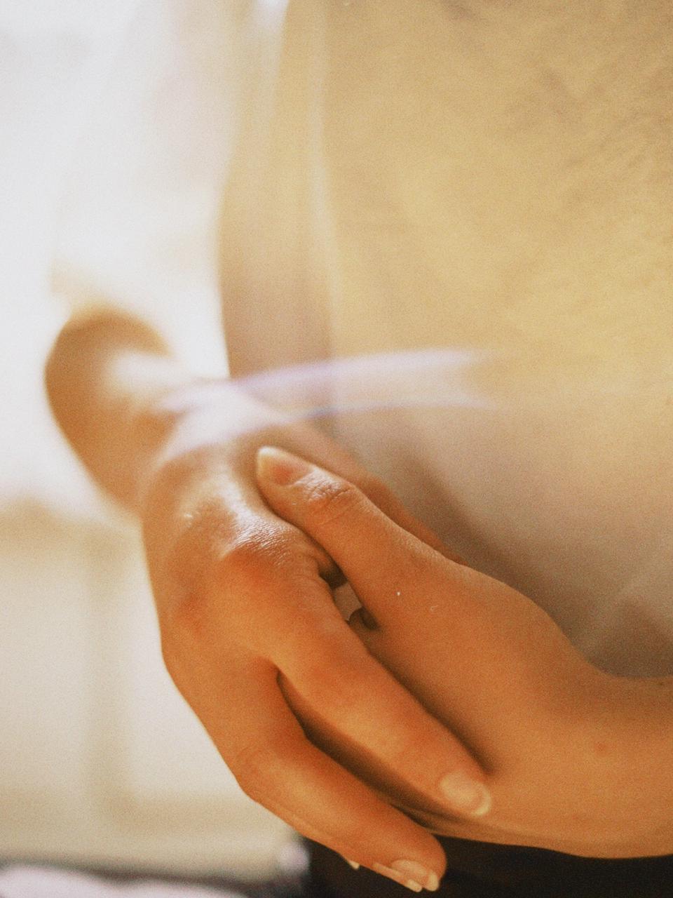 Hands resting softly in morning light
